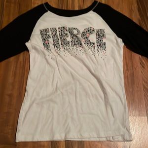 A long sleeved shirt, cropped sleeves and says “fierce”, girl L, from xersion.